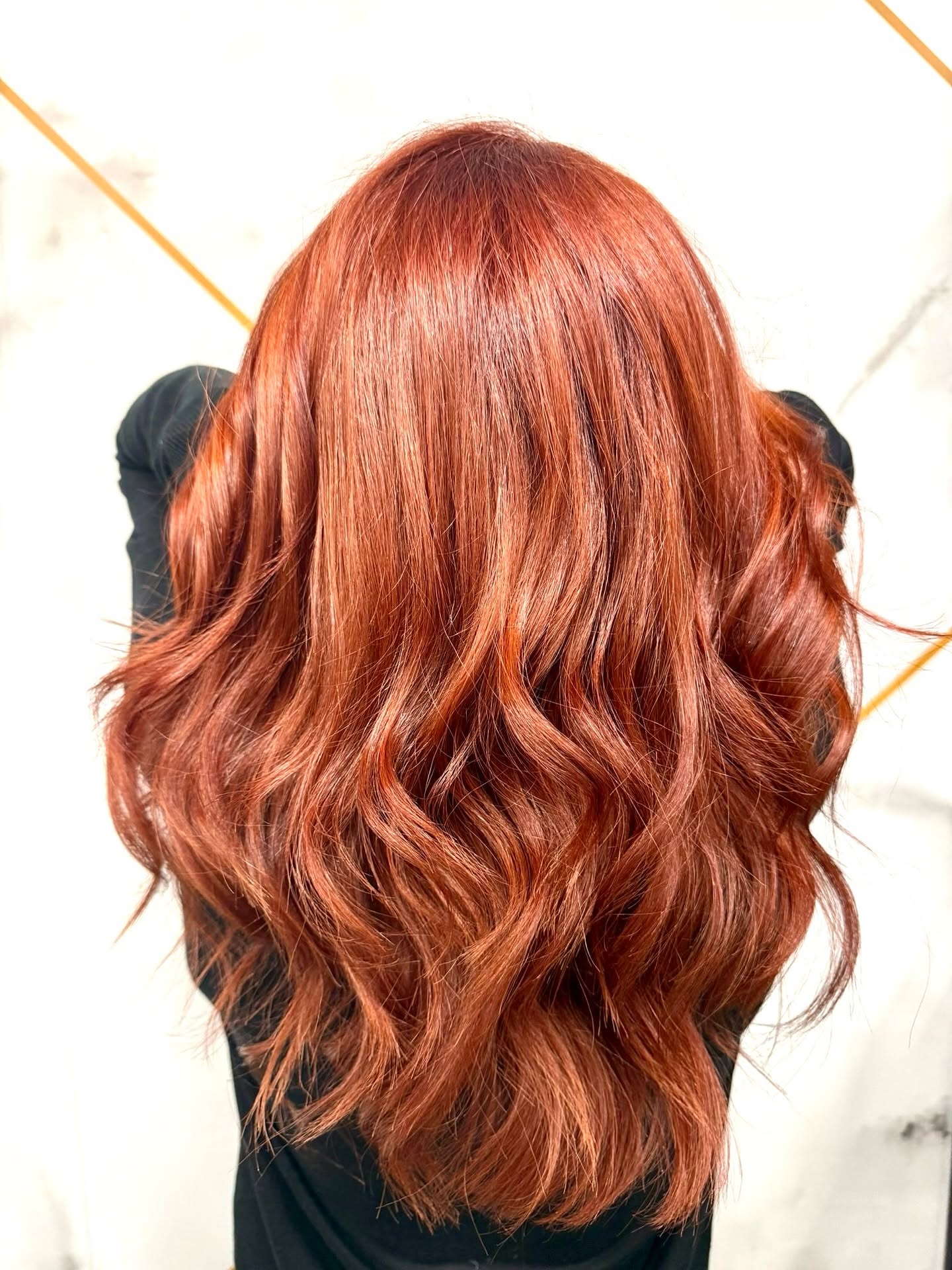 Hair after treatment — glossy copper waves